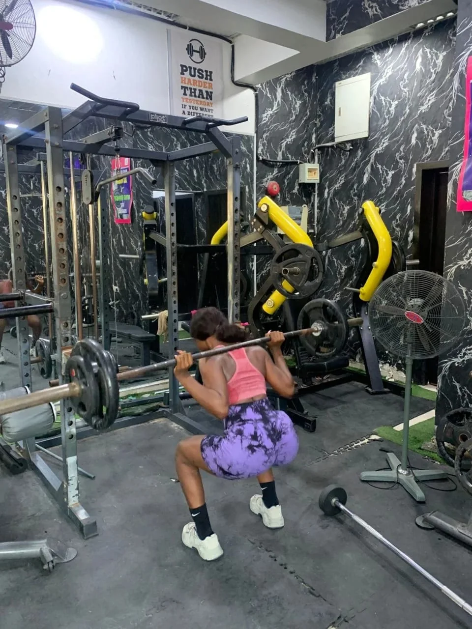 Member performing a squat on the Fitness Arcade gym floor